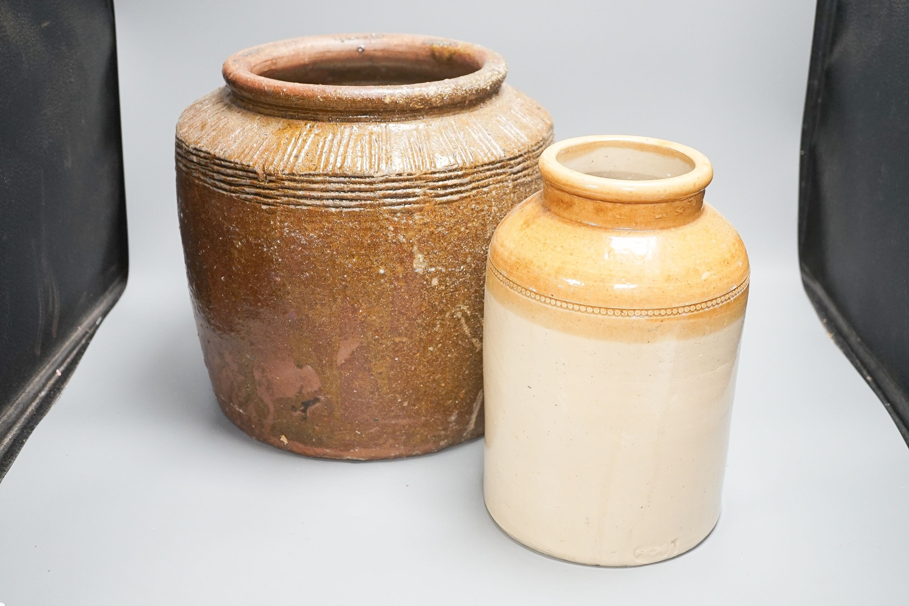 Two stoneware storage jars, largest 30cm